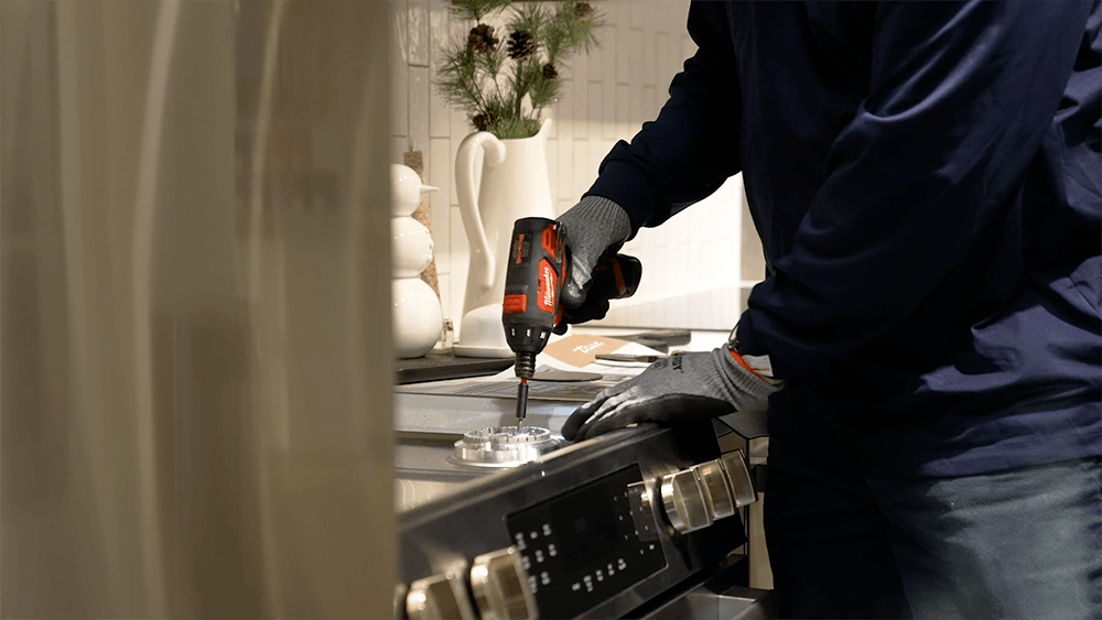 Yale-Appliance-Service-Technician-Working-on-Gas-Range