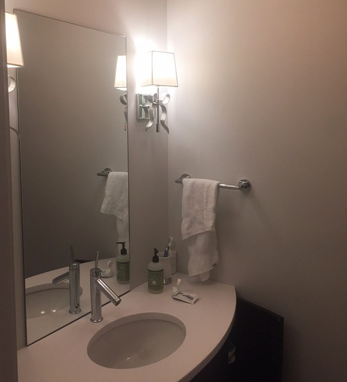 Sconces on either side of the mirror -Steve's vanity