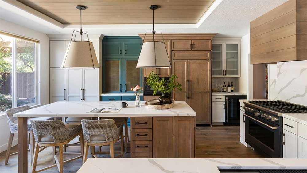 Custom-panel kitchen with pro range beneath a high-CFM wood range hood.
